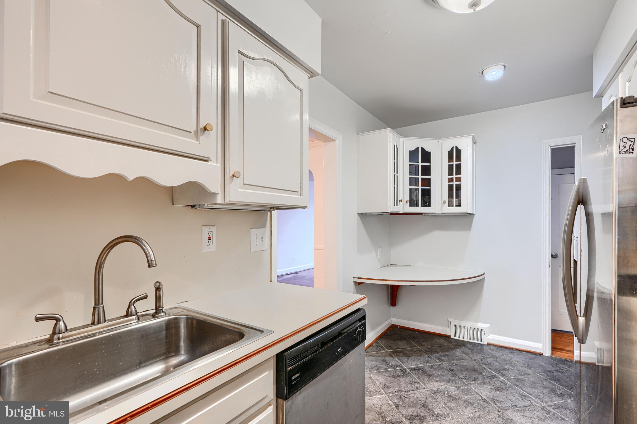 8235 Pleasant Plains Road Towson, MD 21286 - Photo 11 of 42 a close view of a sink and a refrigerator in a kitchen