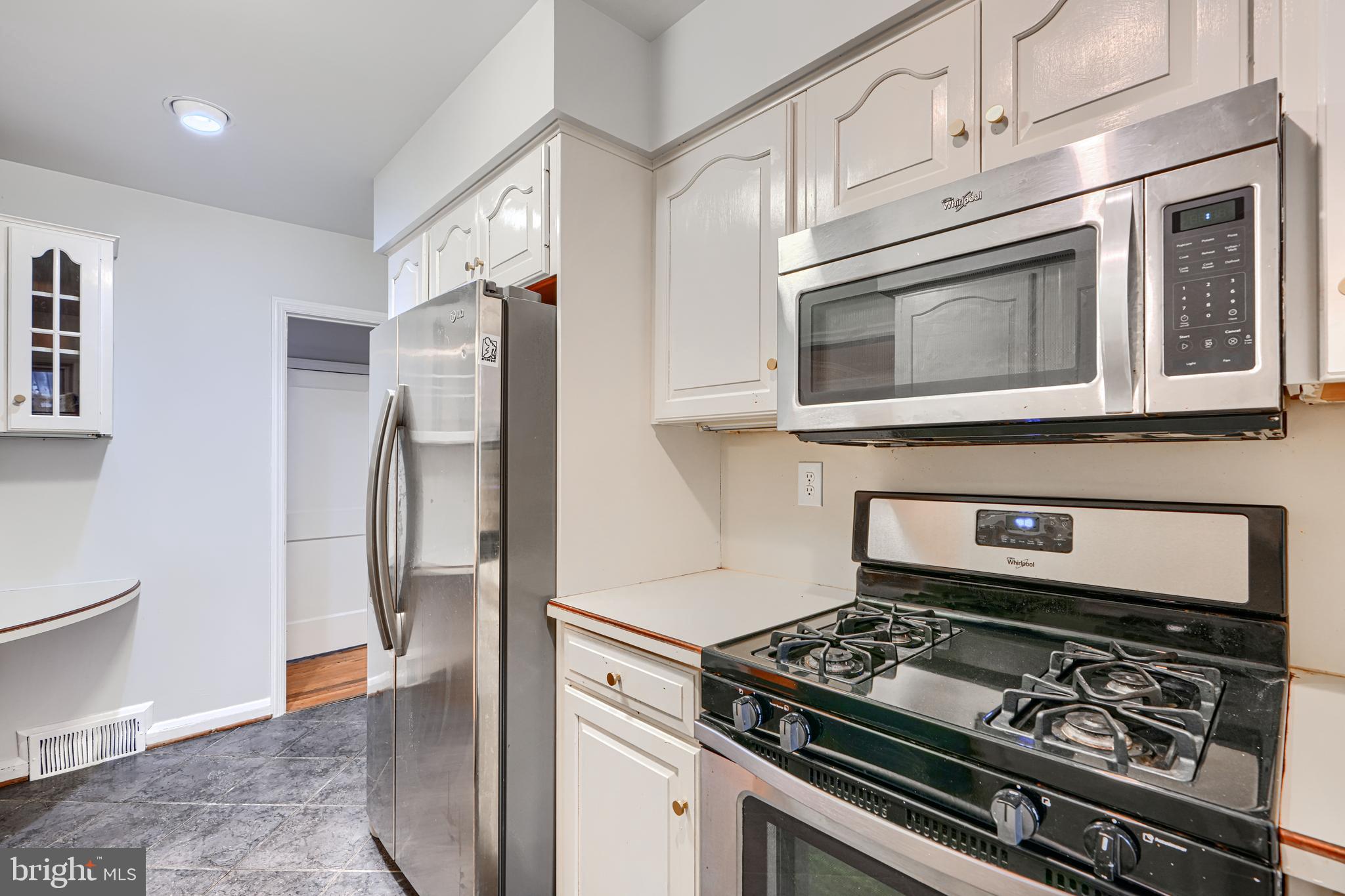 8235 Pleasant Plains Road Towson, MD 21286 - Photo 12 of 42 a kitchen with stainless steel appliances granite countertop a stove and a refrigerator