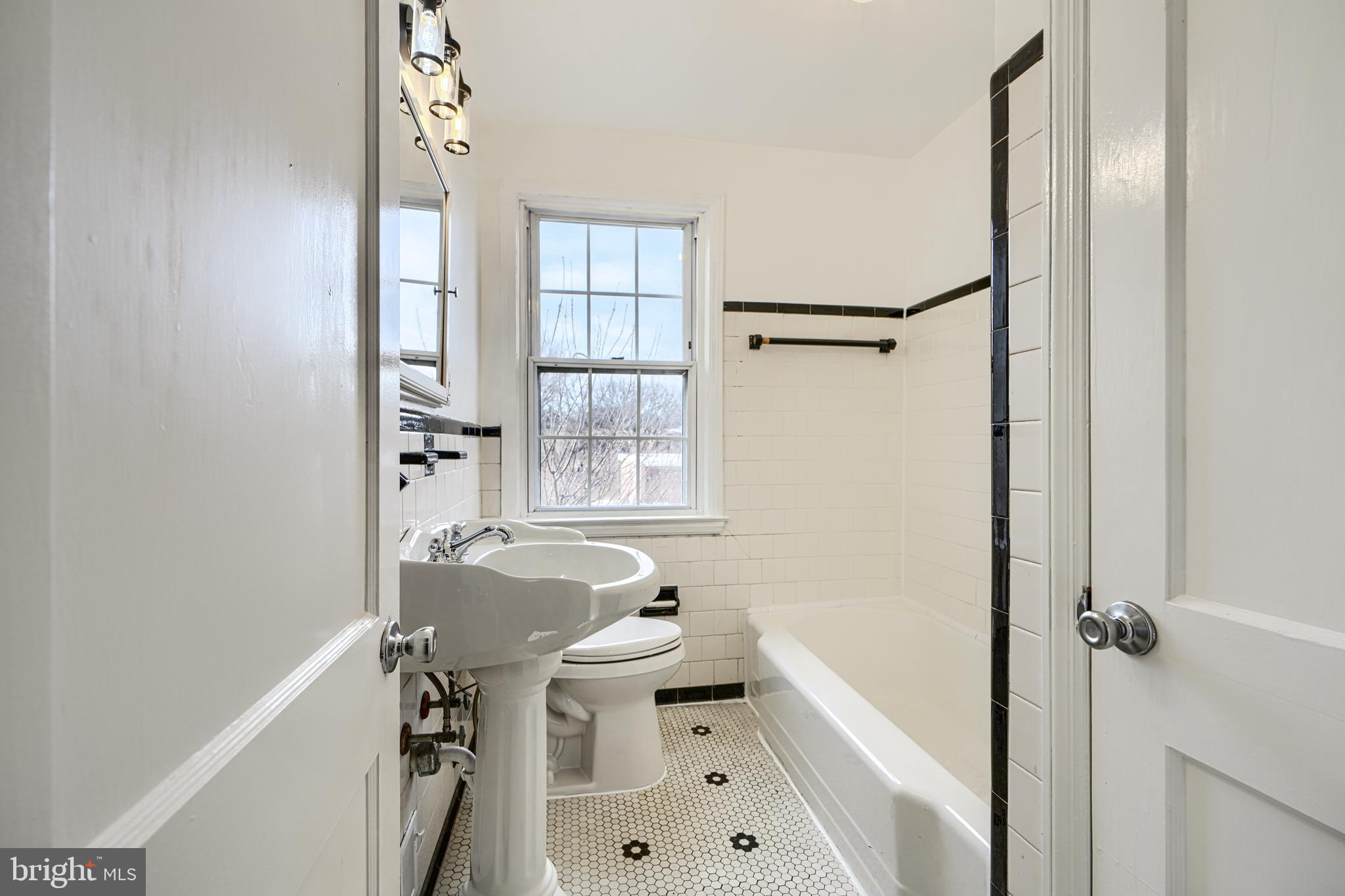 8235 Pleasant Plains Road Towson, MD 21286 - Photo 19 of 42 a bathroom with a sink toilet and shower