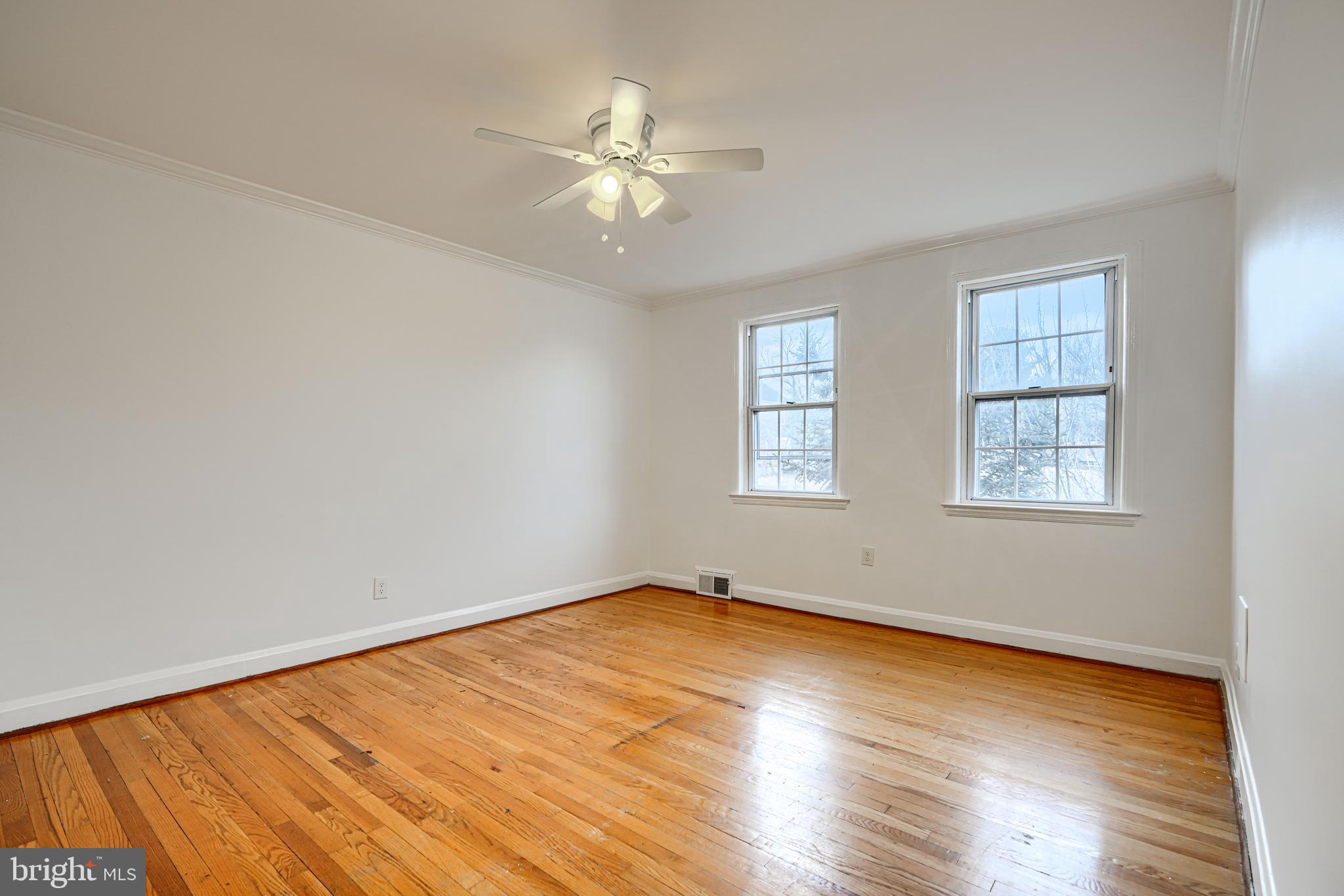 8235 Pleasant Plains Road Towson, MD 21286 - Photo 24 of 42 a view of an empty room with wooden floor and a window