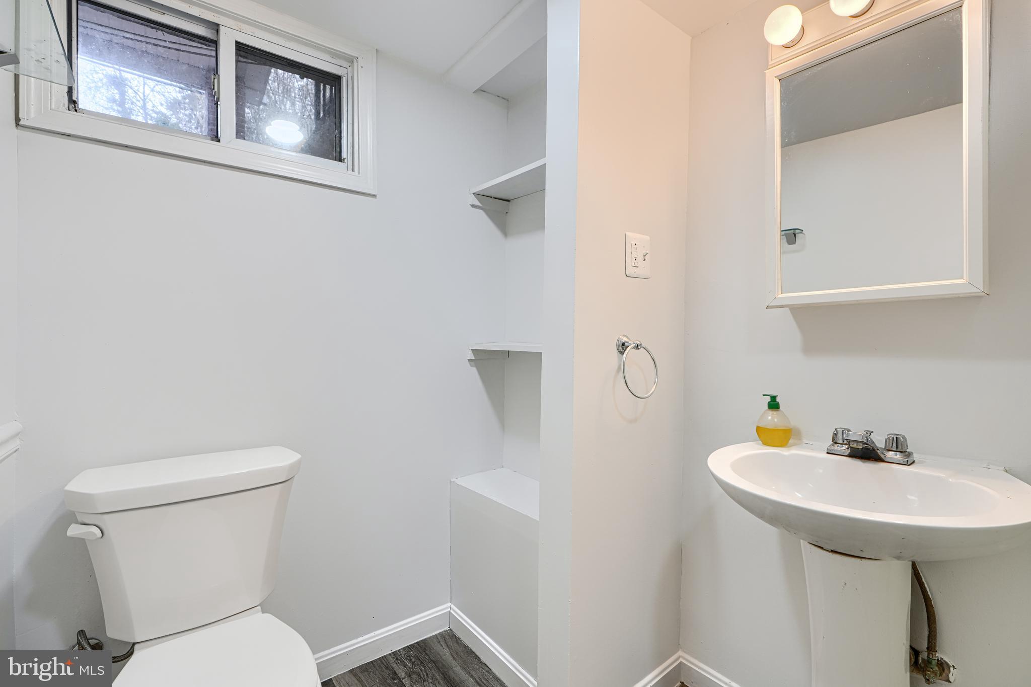 8235 Pleasant Plains Road Towson, MD 21286 - Photo 33 of 42 a bathroom with a toilet a sink and mirror