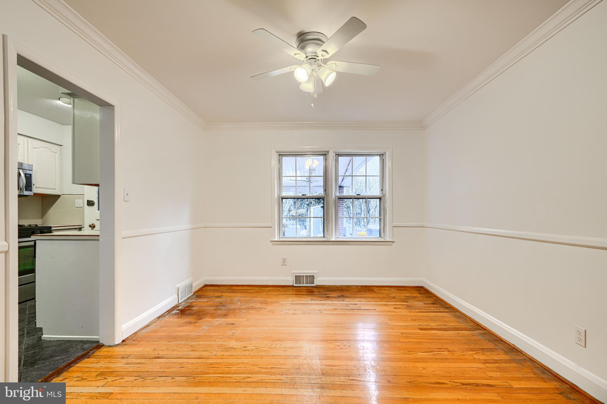 8235 Pleasant Plains Road Towson, MD 21286 - Photo 8 of 42 a view of a room with wooden floor and a ceiling fan