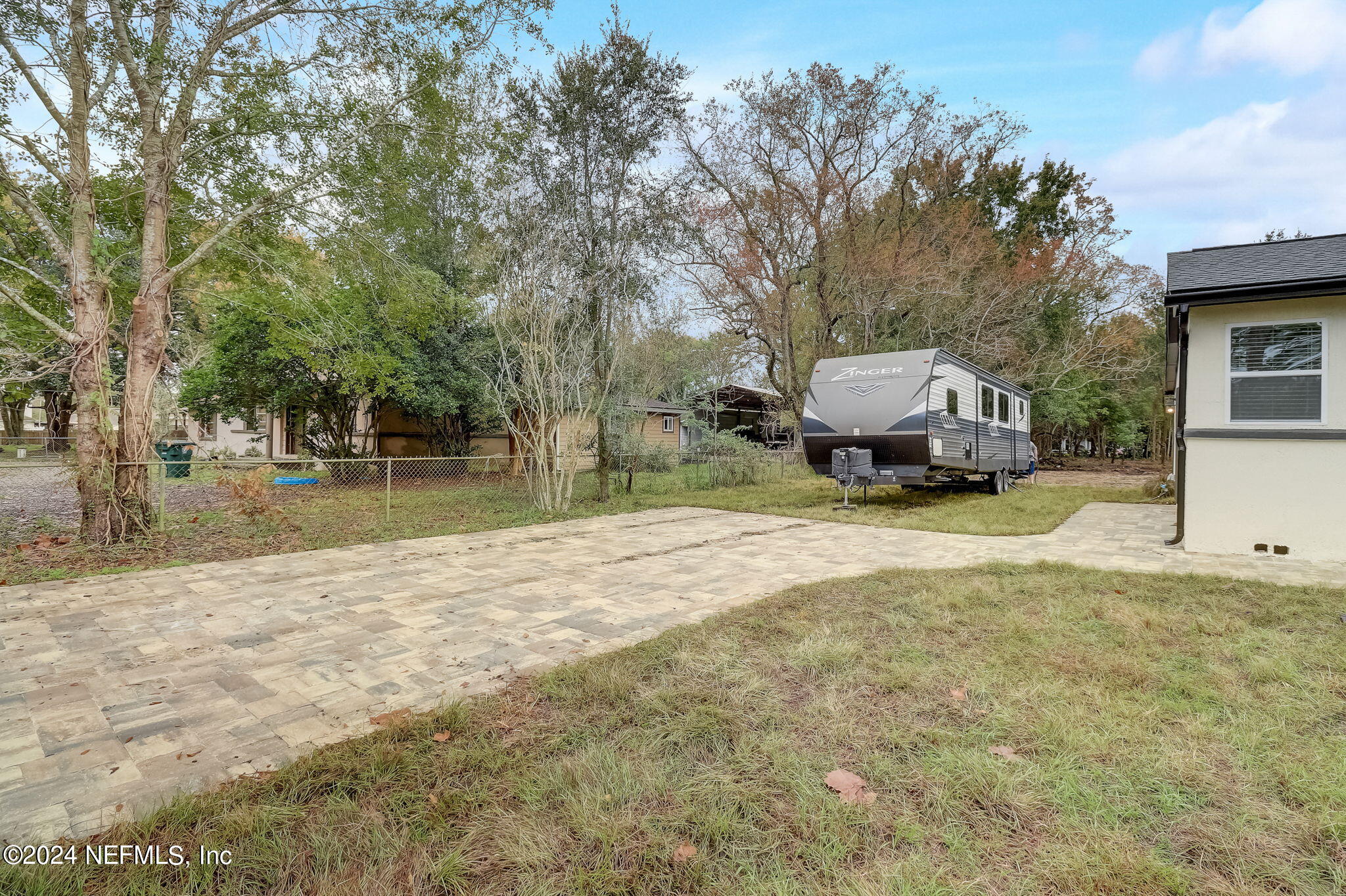 a yellow house with trees in front of it