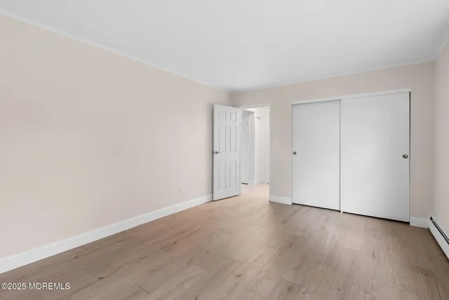 a view of a brick house that has large windows
