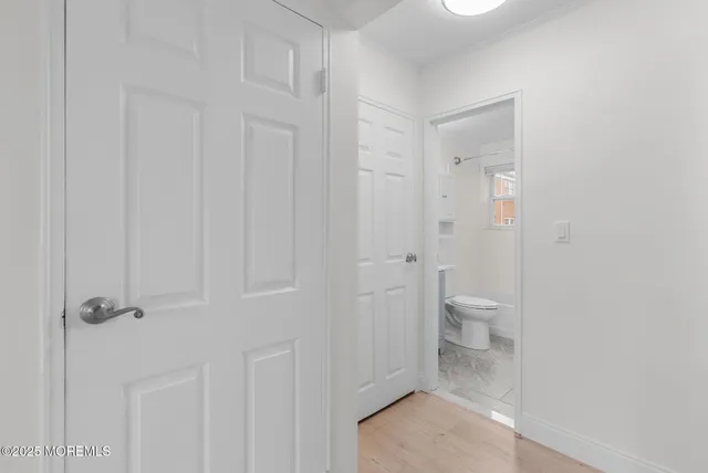 a bathroom with a sink toilet vanity and tub