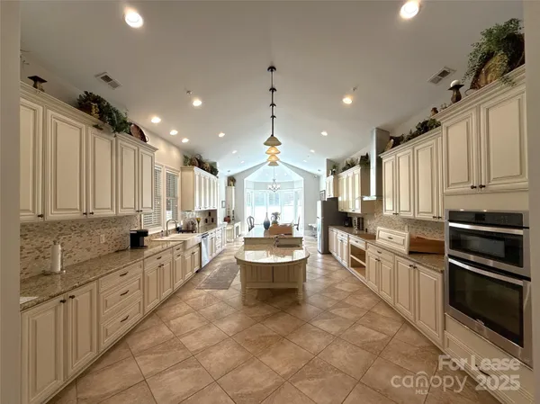 a kitchen with a stove a sink and a refrigerator