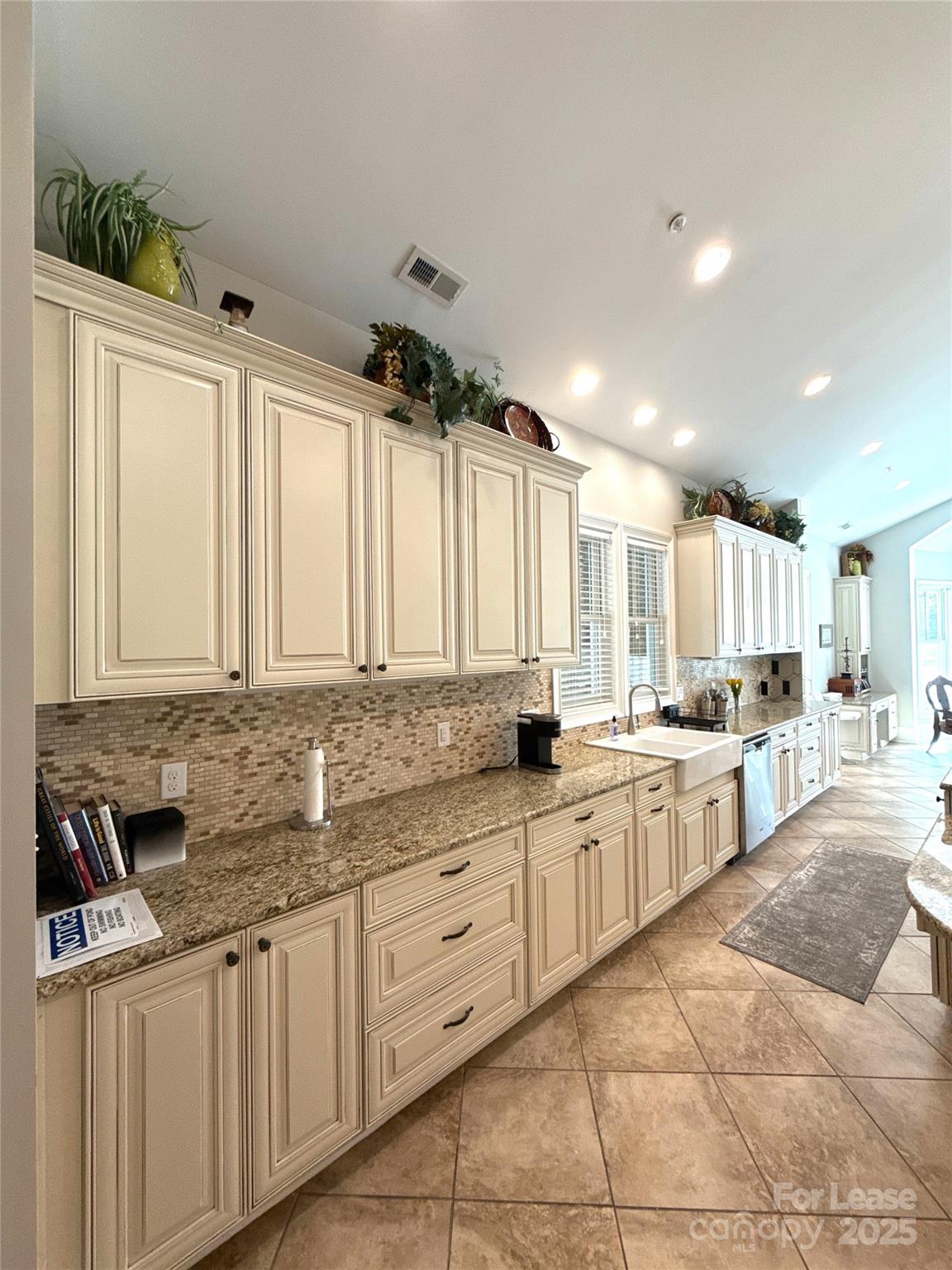14019 Thompson Road Charlotte, NC 28227 - Photo 13 of 43 a large kitchen with kitchen island granite countertop a sink and white cabinets