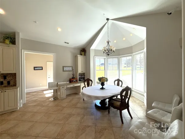 a kitchen with stainless steel appliances granite countertop a sink a refrigerator and a stove