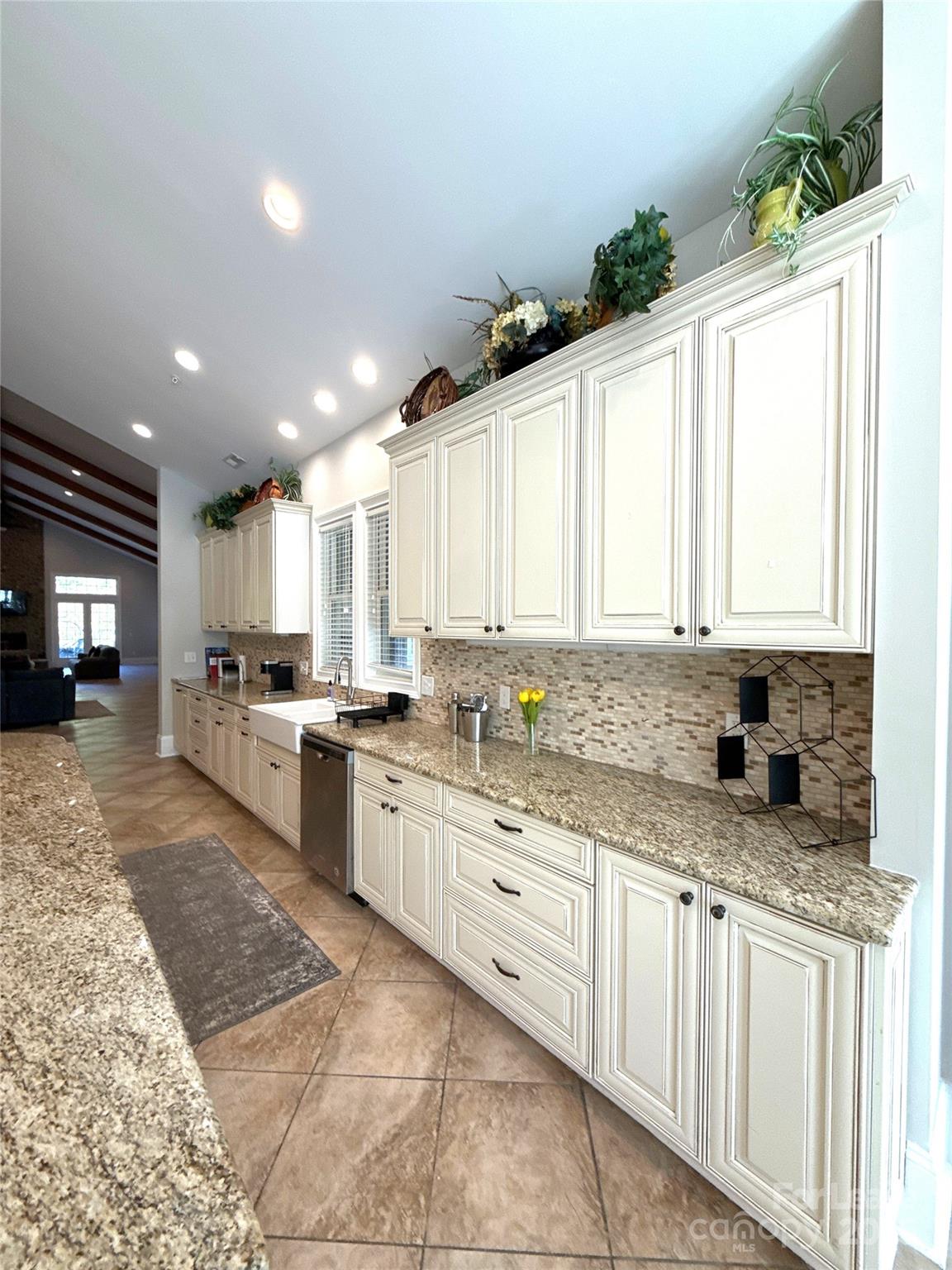 14019 Thompson Road Charlotte, NC 28227 - Photo 16 of 43 a large kitchen with granite countertop a sink white cabinets and a granite counter tops