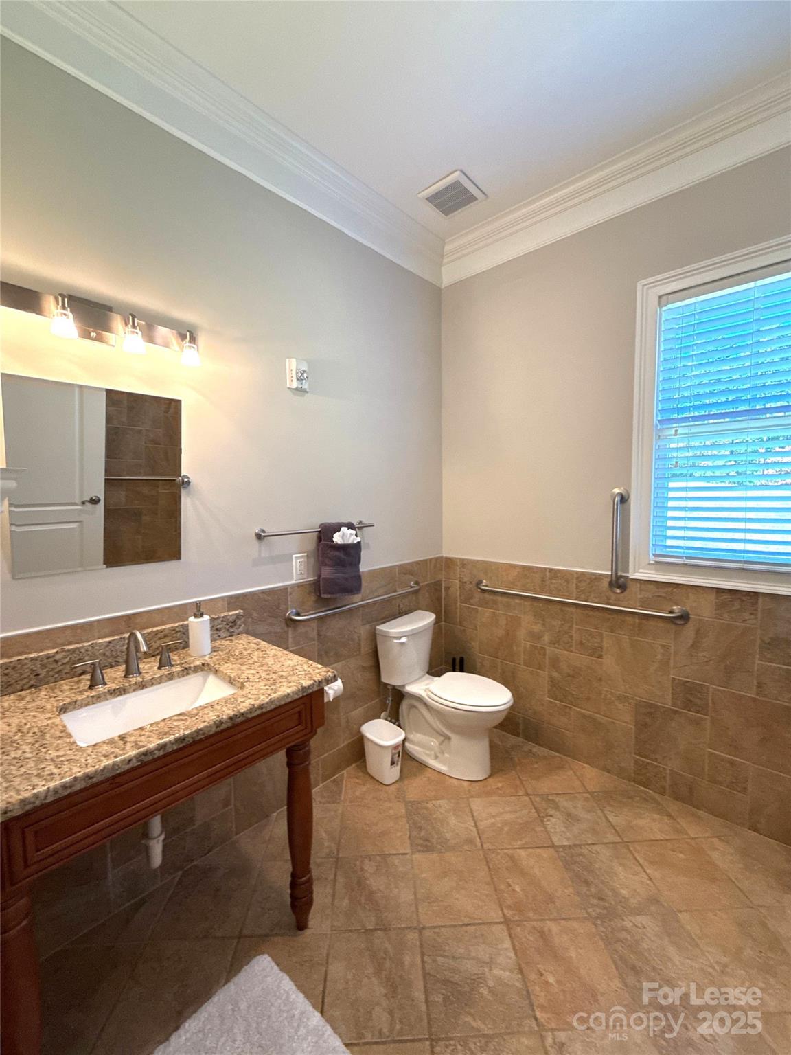 14019 Thompson Road Charlotte, NC 28227 - Photo 21 of 43 a bathroom with a toilet sink and mirror
