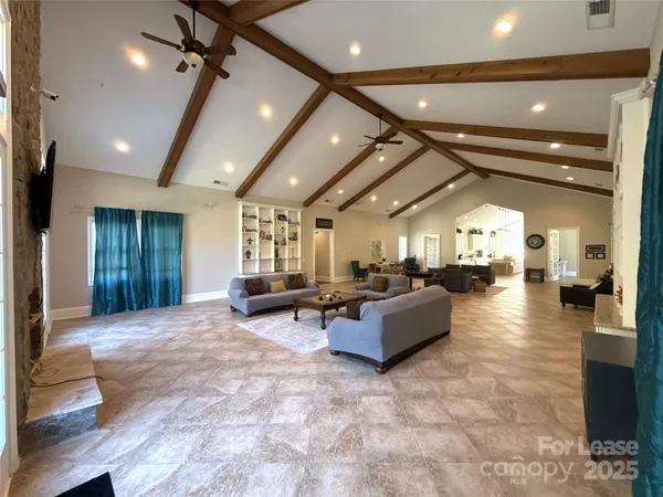 a living room with fireplace furniture and a large window