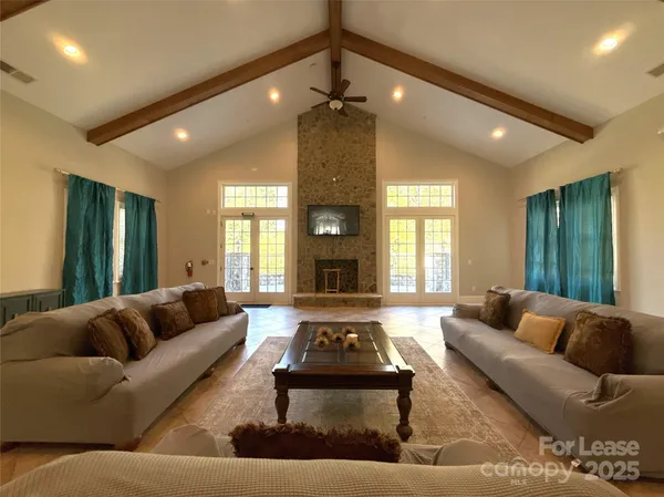 a living room with furniture a large window and rug