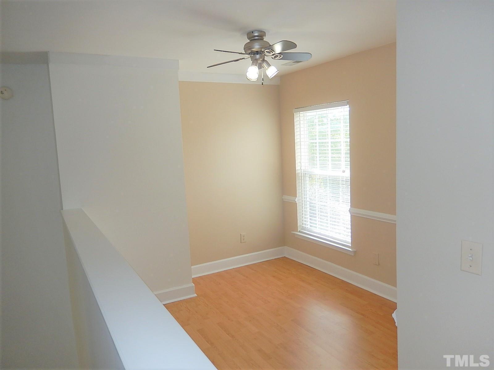 4717 Delta Ridge Court Raleigh, NC 27612 - Photo 18 of 30 an empty room with windows and ceiling fan