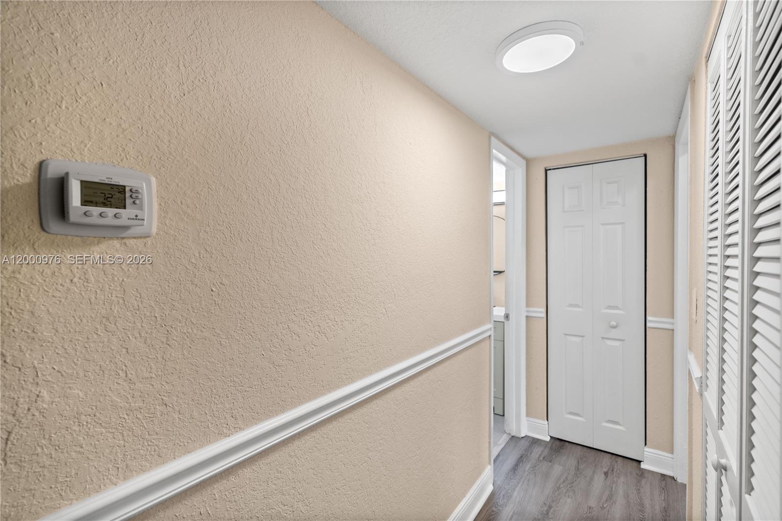 9441 Southwest 76th Street, Unit V32 Miami, FL 33173 - Photo 14 of 28 a view of a hallway with wooden floor