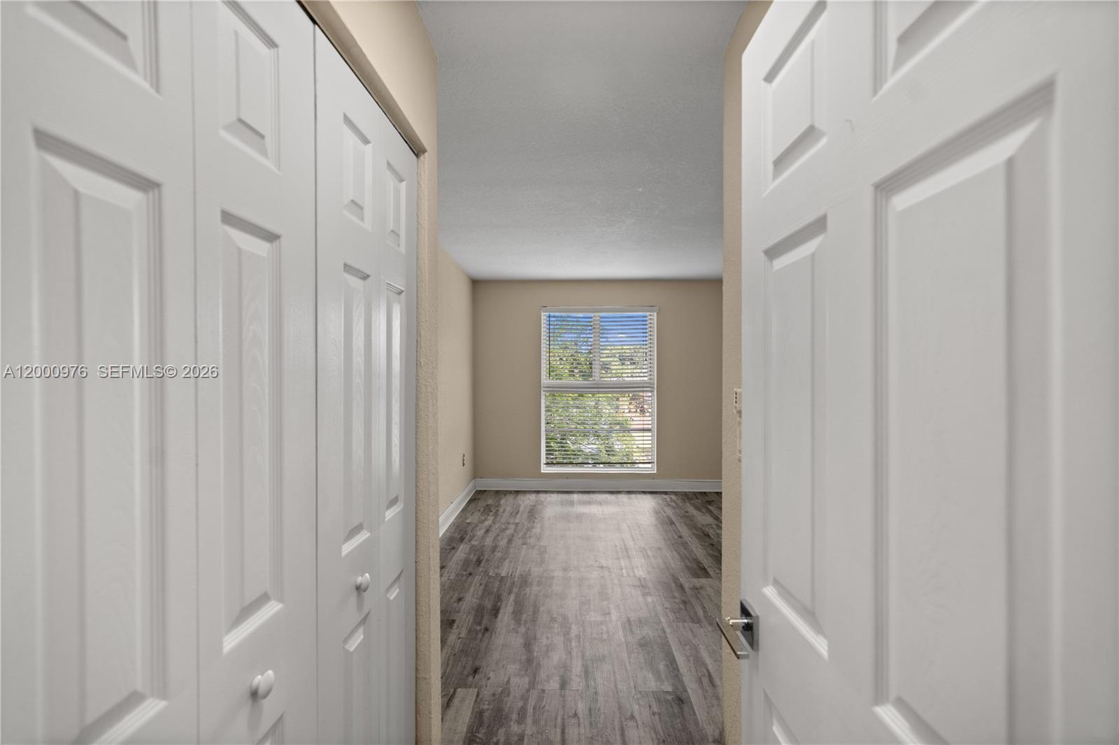9441 Southwest 76th Street, Unit V32 Miami, FL 33173 - Photo 15 of 28 a view of a hallway with wooden floor and a window
