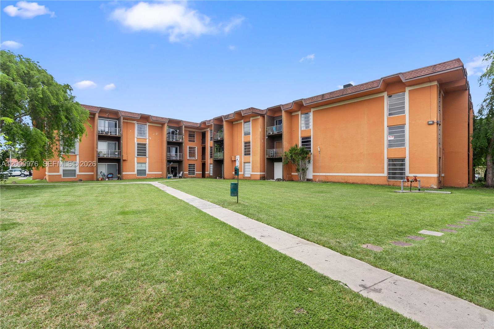 9441 Southwest 76th Street, Unit V32 Miami, FL 33173 - Photo 22 of 28 a front view of house with yard