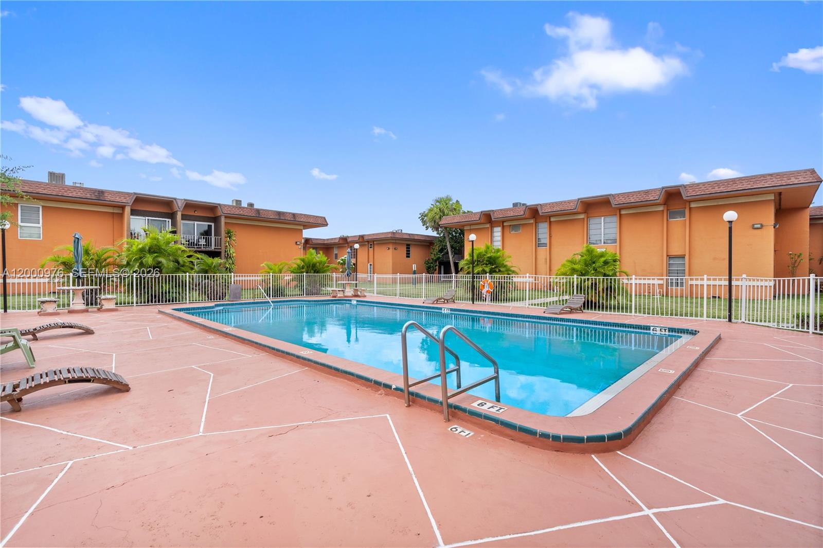 9441 Southwest 76th Street, Unit V32 Miami, FL 33173 - Photo 27 of 28 a view of a swimming pool with a patio