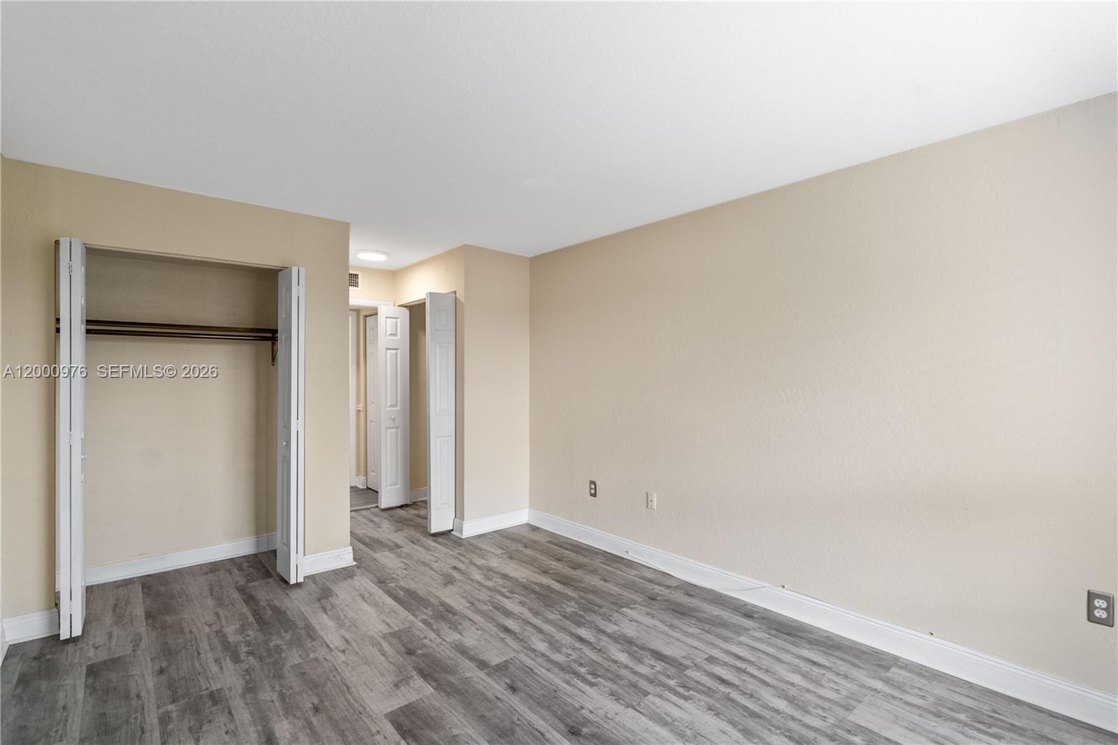 9441 Southwest 76th Street, Unit V32 Miami, FL 33173 - Photo 6 of 28 a view of an empty room and wooden floor