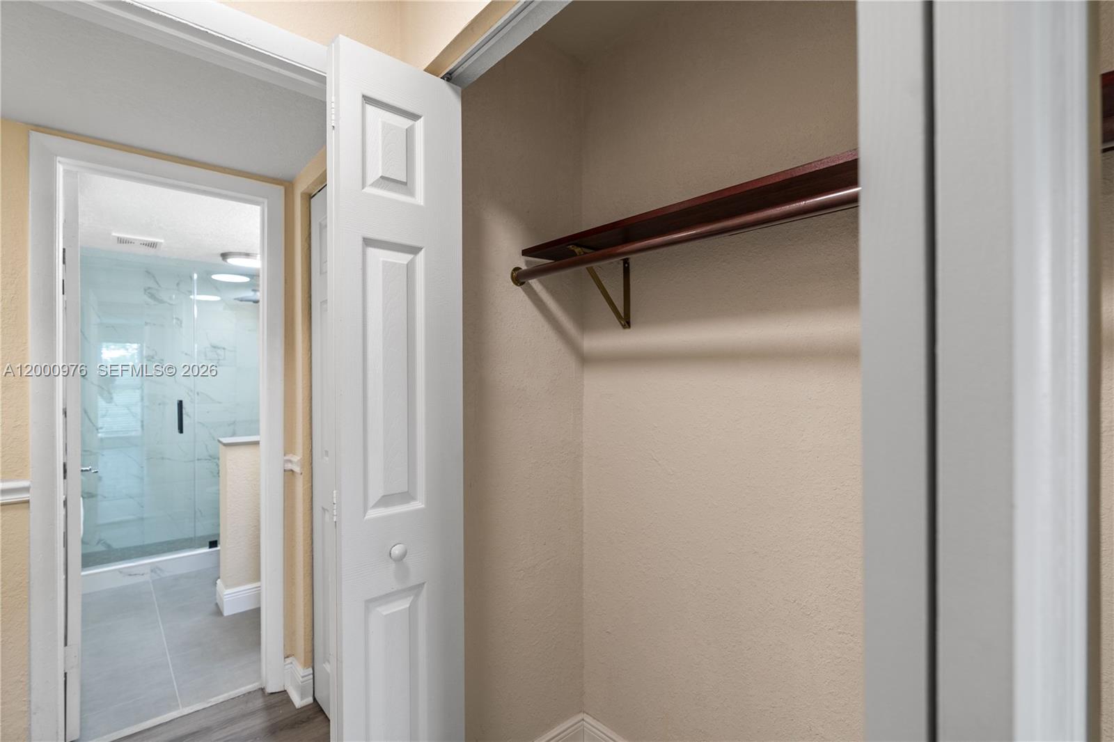 9441 Southwest 76th Street, Unit V32 Miami, FL 33173 - Photo 7 of 28 a bathroom with a glass shower door
