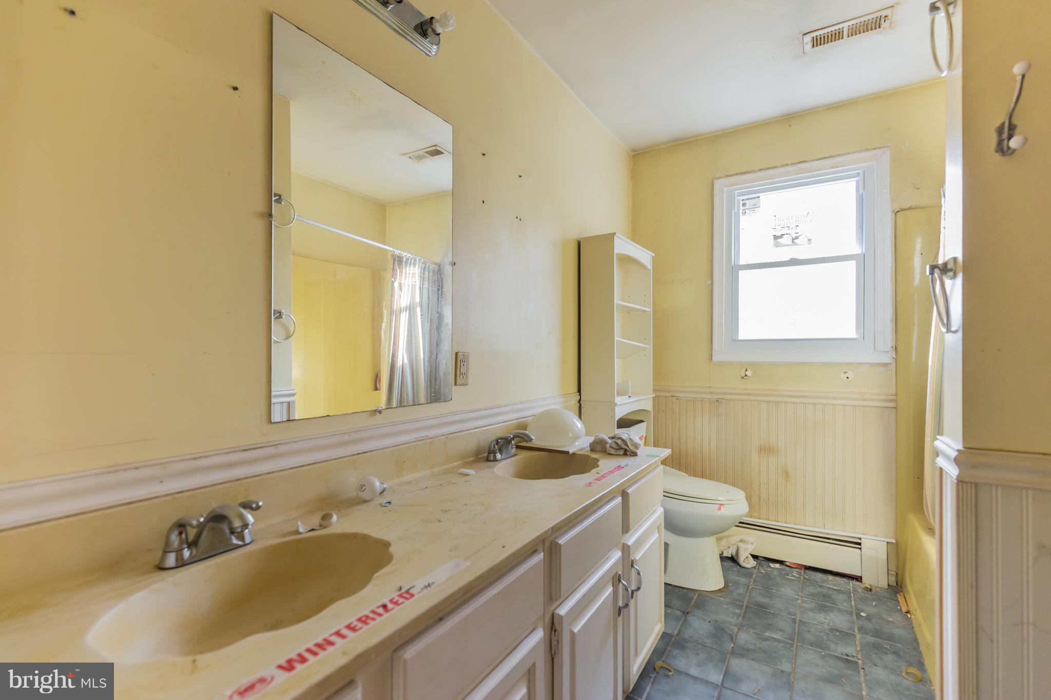369 Friendship Road Friendship, MD 20758 - Photo 17 of 18 a bathroom with a granite countertop sink and a mirror