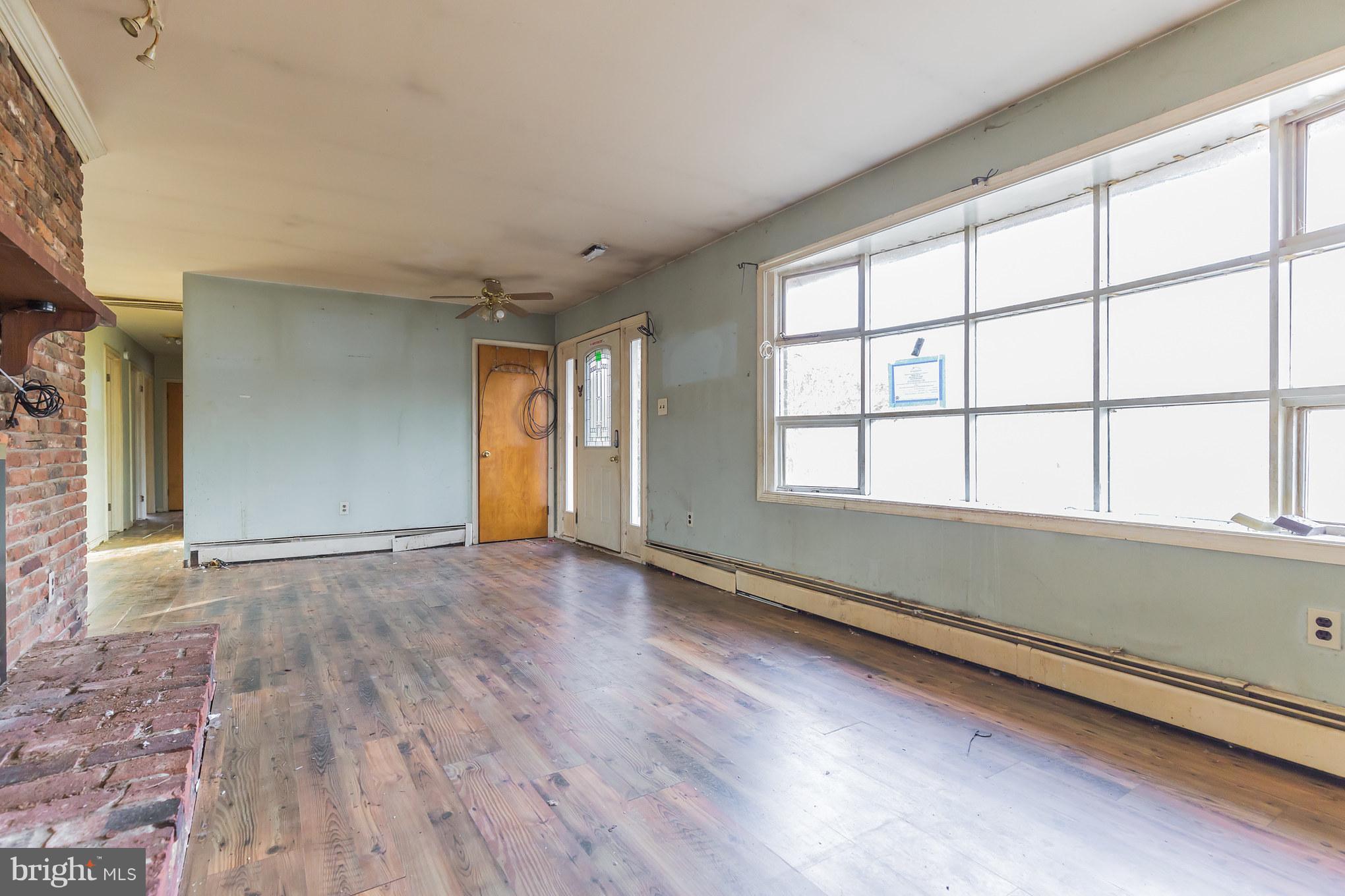 369 Friendship Road Friendship, MD 20758 - Photo 6 of 18 wooden floor in an empty room with a window