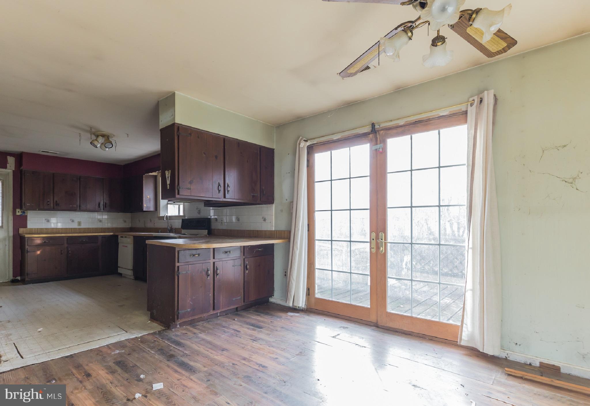 369 Friendship Road Friendship, MD 20758 - Photo 8 of 18 a large kitchen with a large window and stainless steel appliances