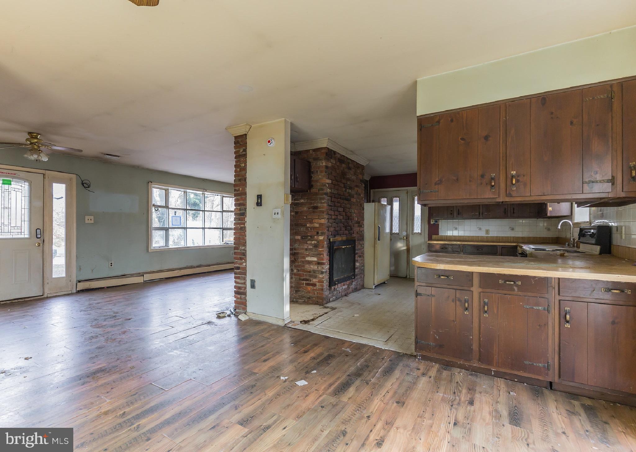 369 Friendship Road Friendship, MD 20758 - Photo 9 of 18 a kitchen with stainless steel appliances granite countertop a stove top oven a sink and a wooden floors