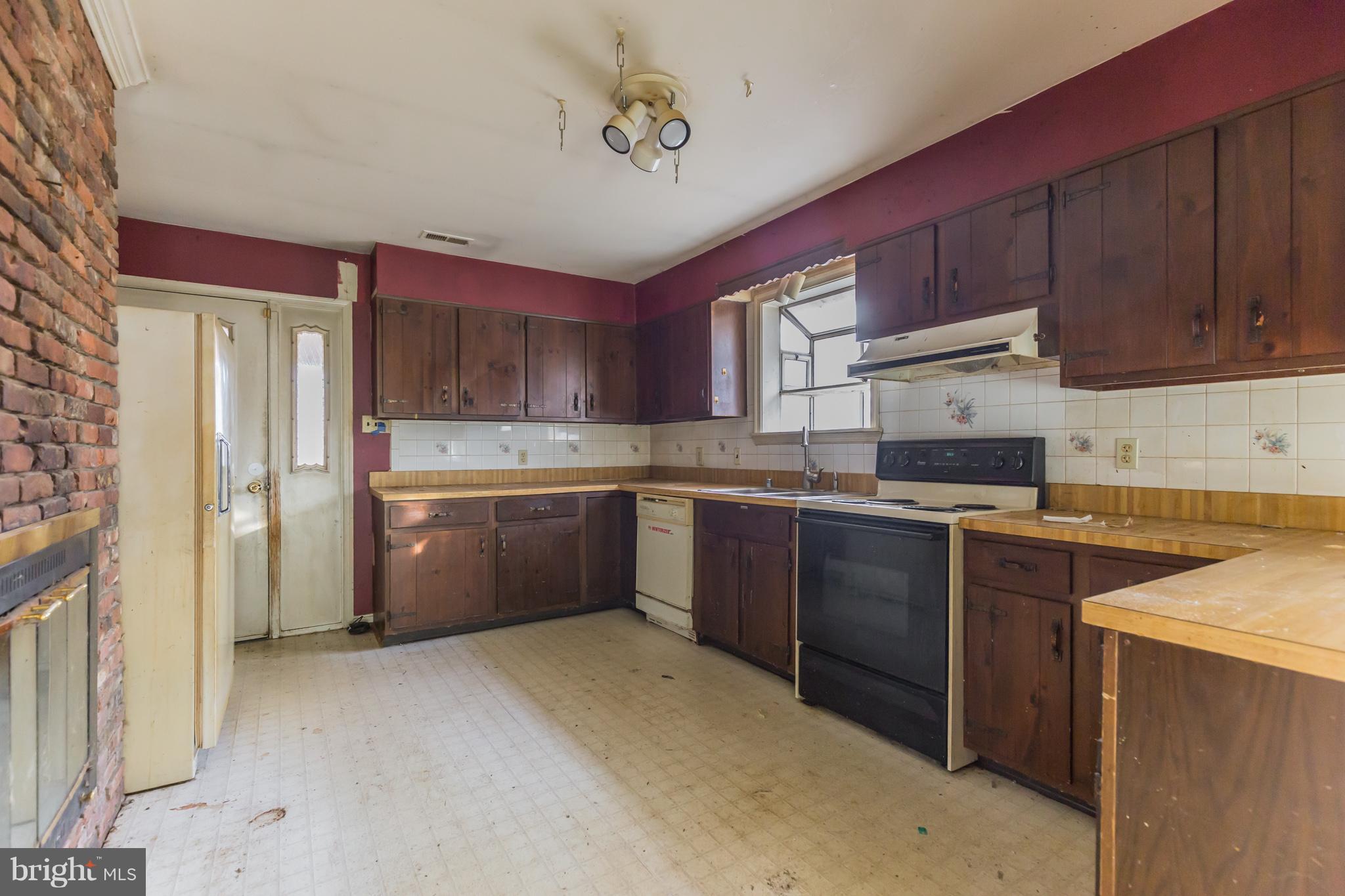 369 Friendship Road Friendship, MD 20758 - Photo 10 of 18 a kitchen with stainless steel appliances granite countertop a stove sink refrigerator and cabinets