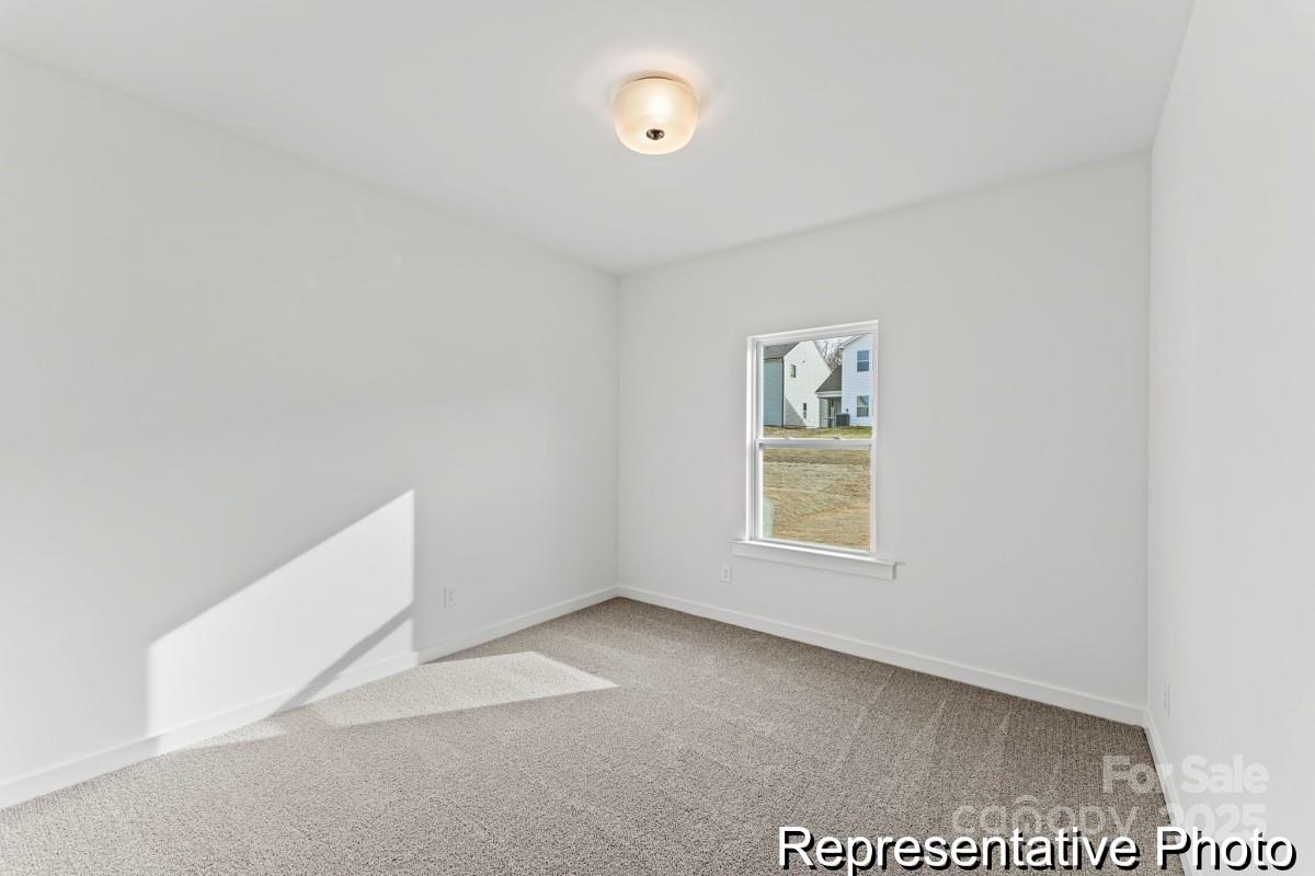 111 West Rice Planters Way, Unit 2P Statesville, NC 28625 - Photo 11 of 19 a view of an empty room with a window