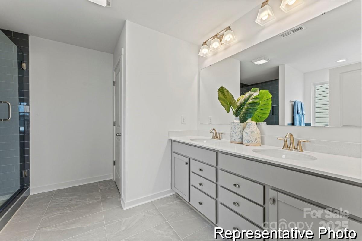 111 West Rice Planters Way, Unit 2P Statesville, NC 28625 - Photo 17 of 19 a bathroom with a double vanity sink and a mirror