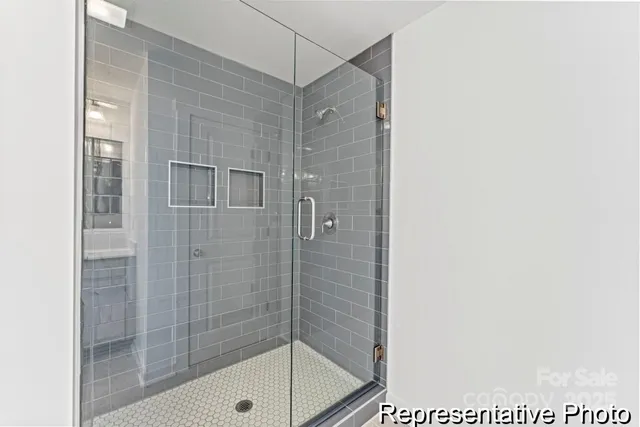 a bathroom with a shower and a sink