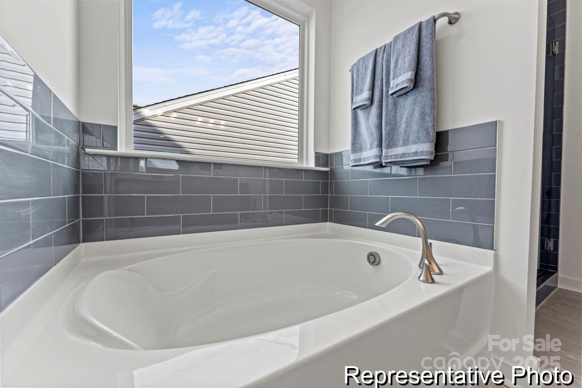 111 West Rice Planters Way, Unit 2P Statesville, NC 28625 - Photo 19 of 19 a white bath tub sitting next to a window