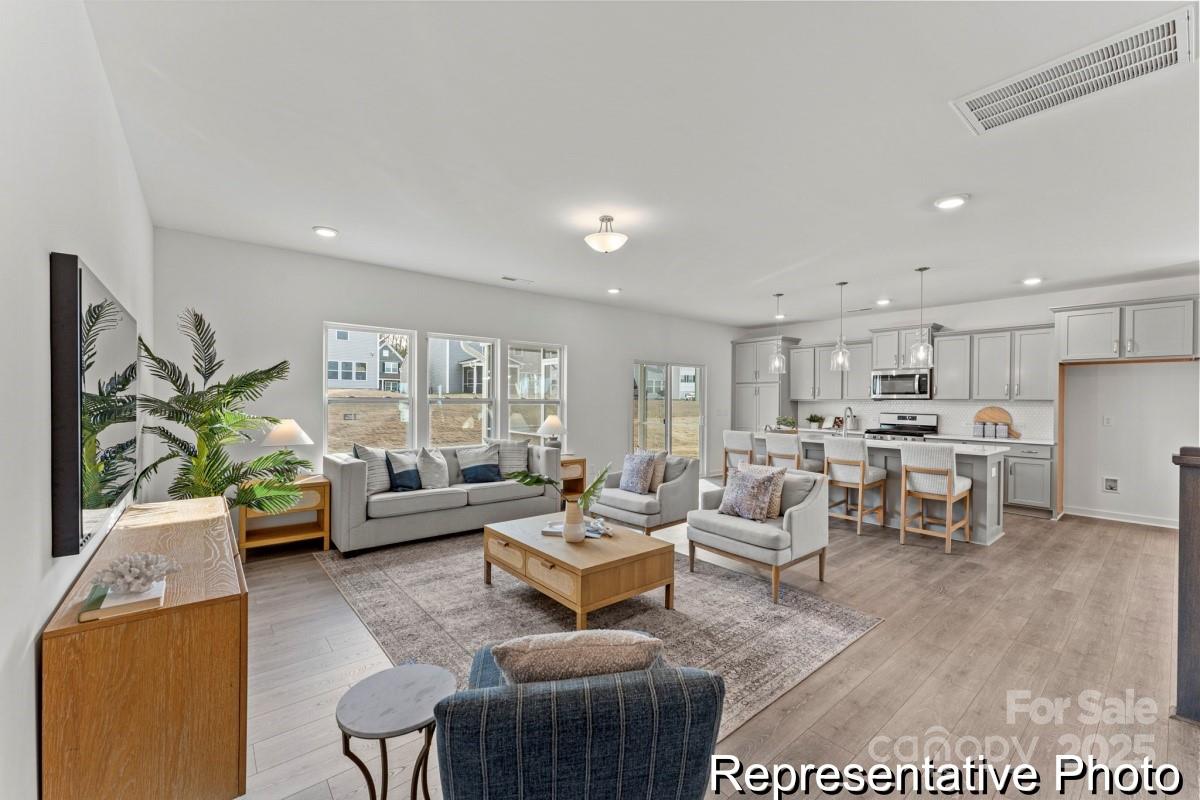 111 West Rice Planters Way, Unit 2P Statesville, NC 28625 - Photo 5 of 19 a living room with furniture and a large window