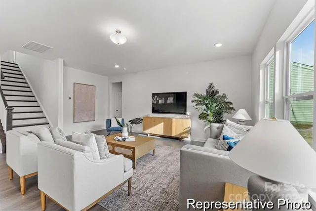 a living room with furniture and a large window
