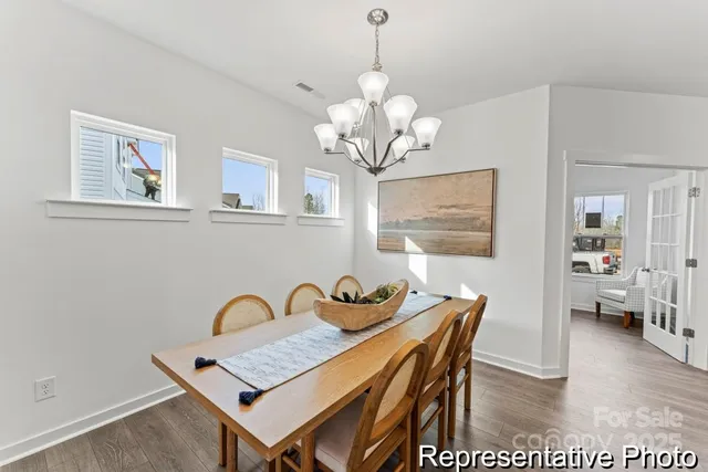 a view of a dining room with furniture wooden floor and a chandelier