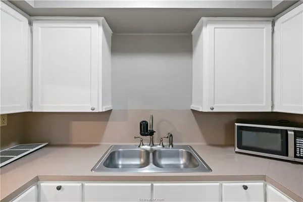 a kitchen with a sink and cabinets