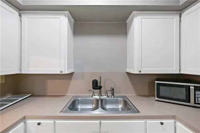 a kitchen with a sink and cabinets