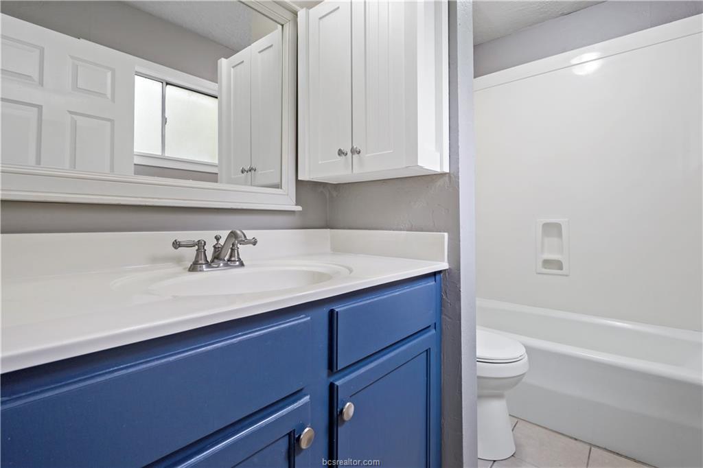 3906 Aspen Street, Unit C Bryan, TX 77801 - Photo 15 of 16 a bathroom with a sink and a toilet