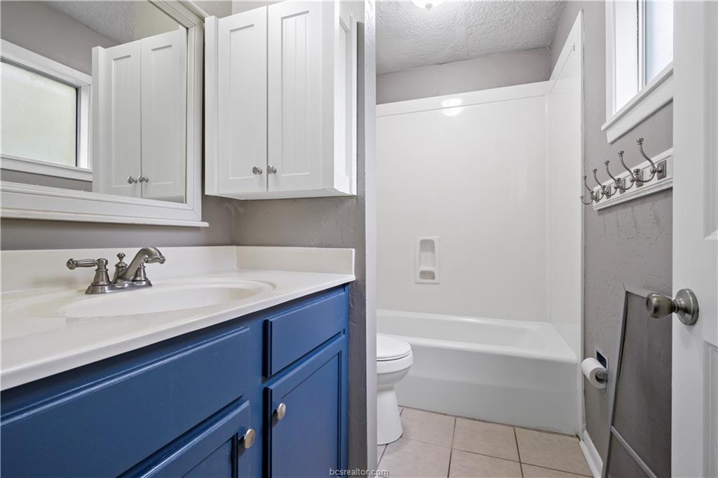 3906 Aspen Street, Unit C Bryan, TX 77801 - Photo 16 of 16 a bath room with a sink a toilet and a tub