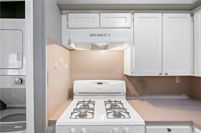 a white stove top oven sitting inside of a kitchen