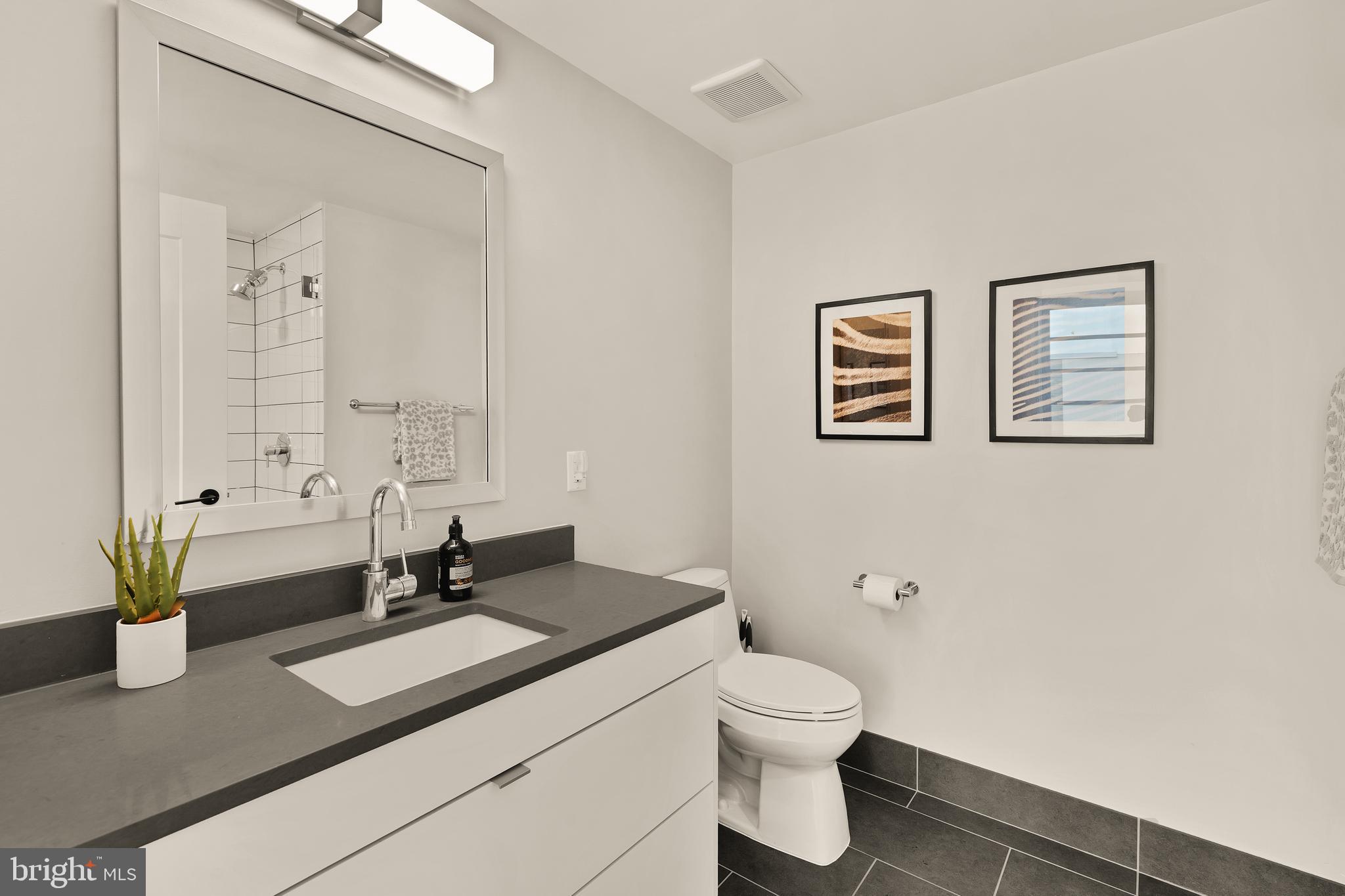 1300 4th Street Southeast, Unit 812 Washington, DC 20003 - Photo 18 of 40 a bathroom with a toilet sink and mirror