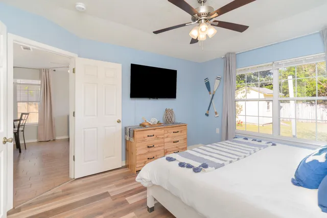 a bedroom with a bed and a flat screen tv