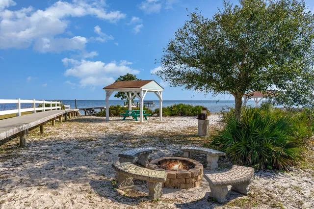 a view of a swimming pool with a patio and a yard