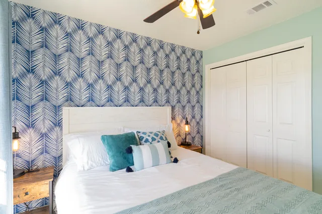 a bedroom with a bed and a painting on the wall