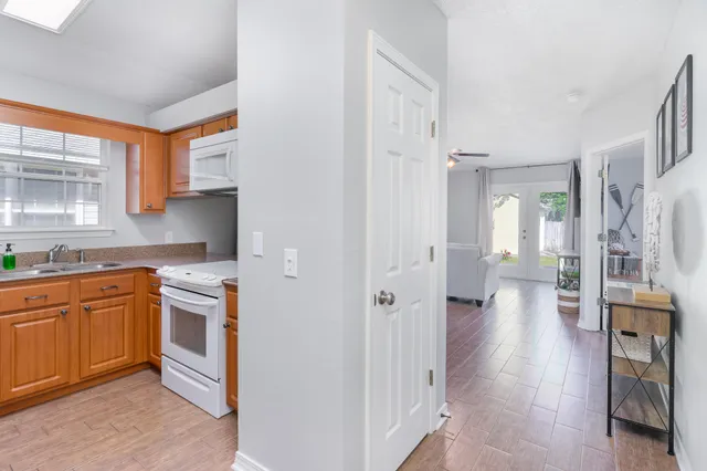a kitchen with cabinets and wooden floor