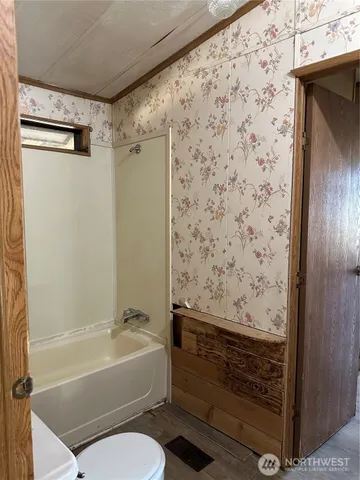 a bathroom with a bathtub and shower