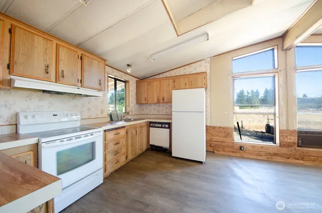 a kitchen with a stove a refrigerator and a sink