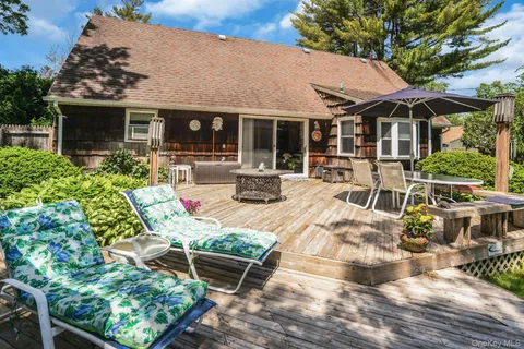 a view of a house with backyard sitting area and porch
