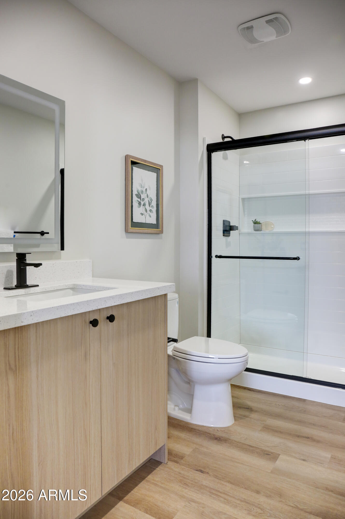 630 North Power Road, Unit 102 Mesa, AZ 85205 - Photo 5 of 13 a bathroom with a sink mirror toilet and vanity