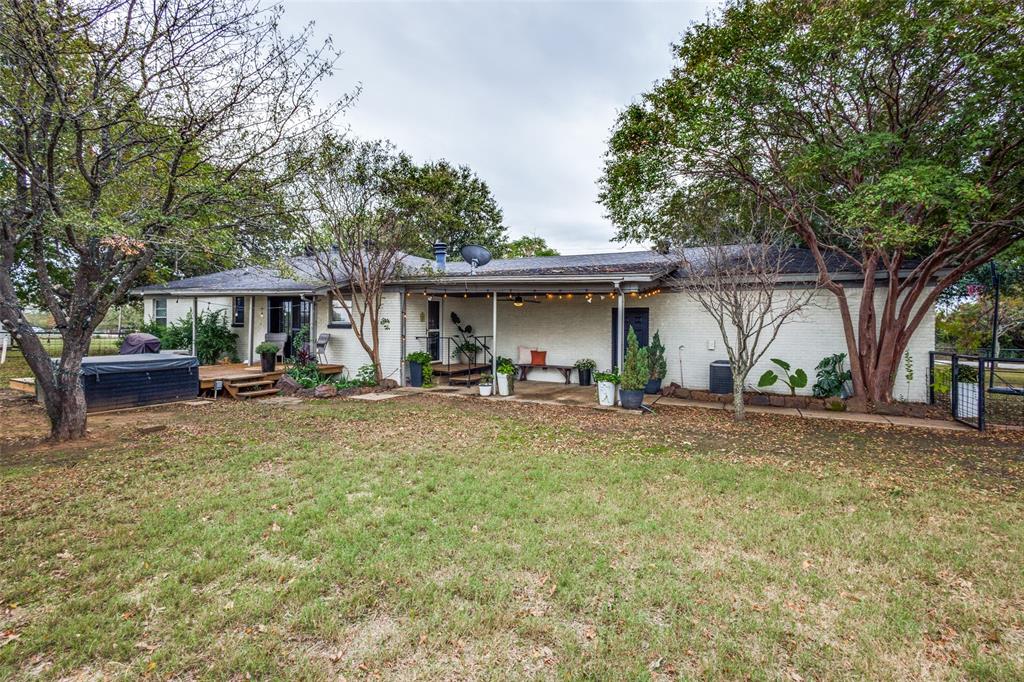 1200 Tipps Road Cross Roads, TX 76227 - Photo 26 of 32 a view of a house with backyard and sitting area